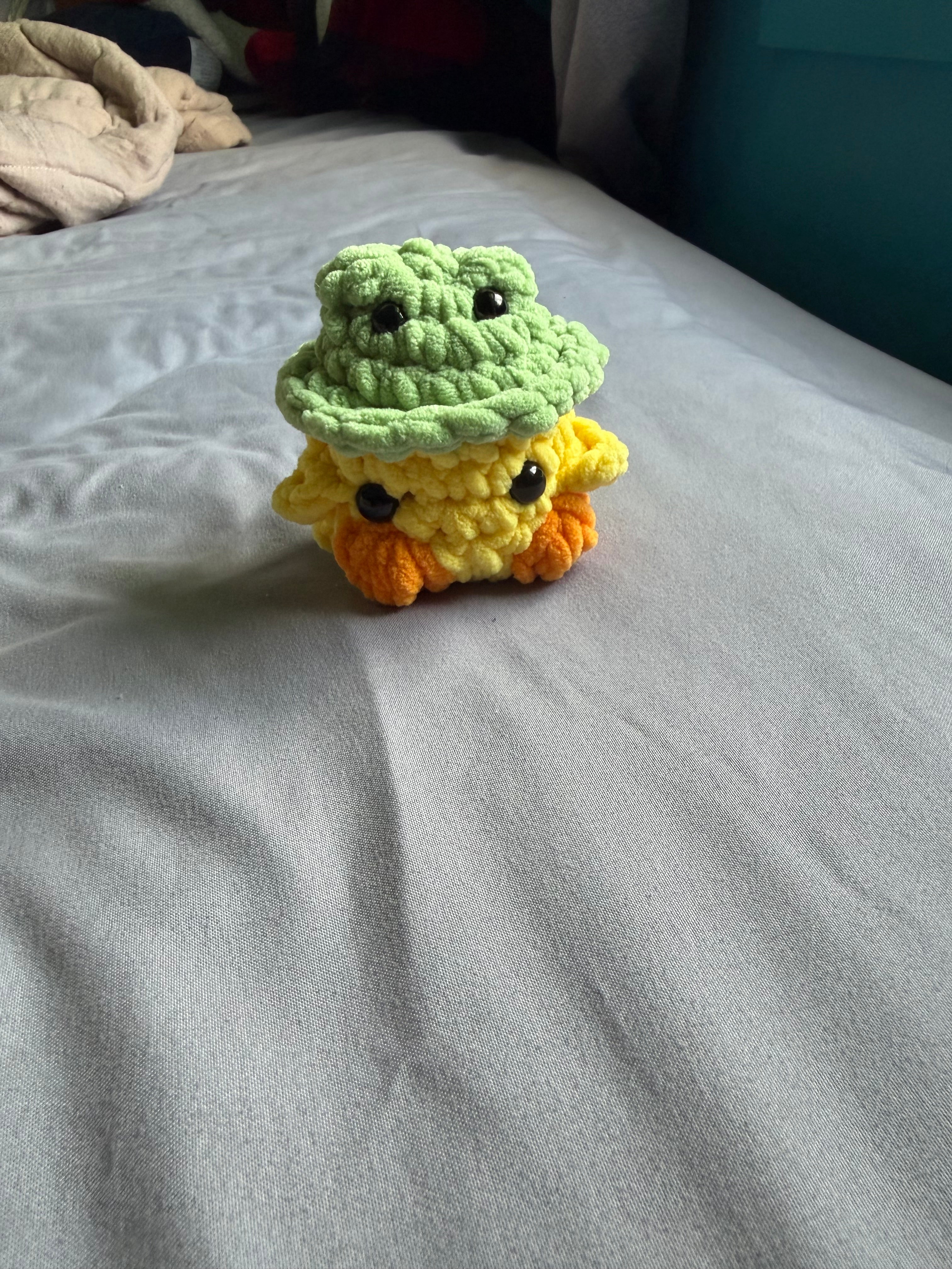 Chick wearing a frog hat